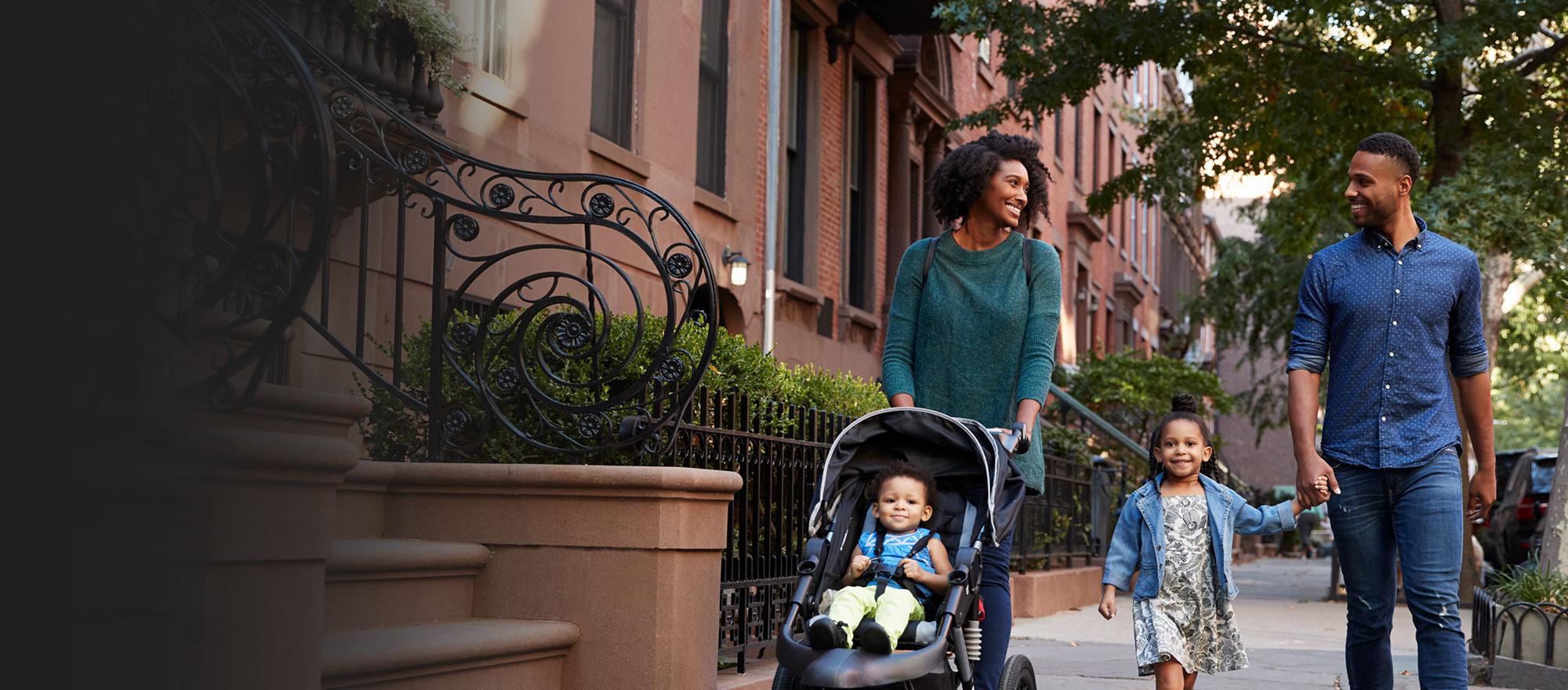 Happy family safely walking down the street