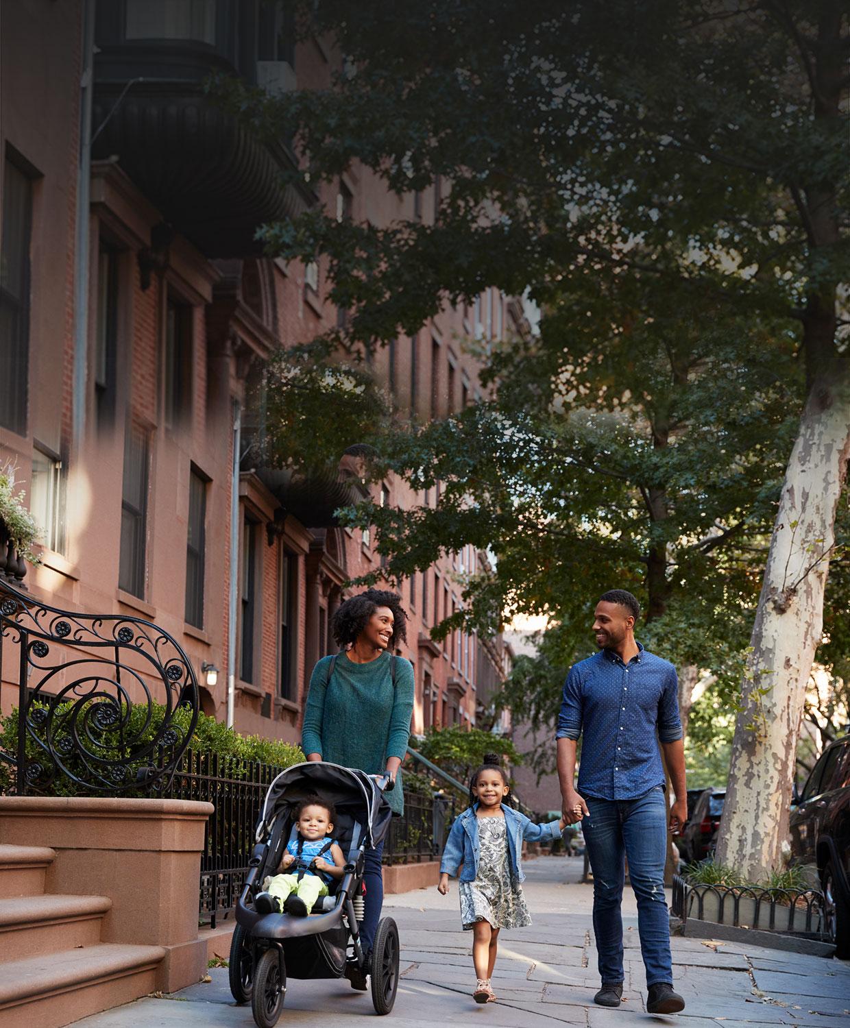 Happy family safely walking down the street