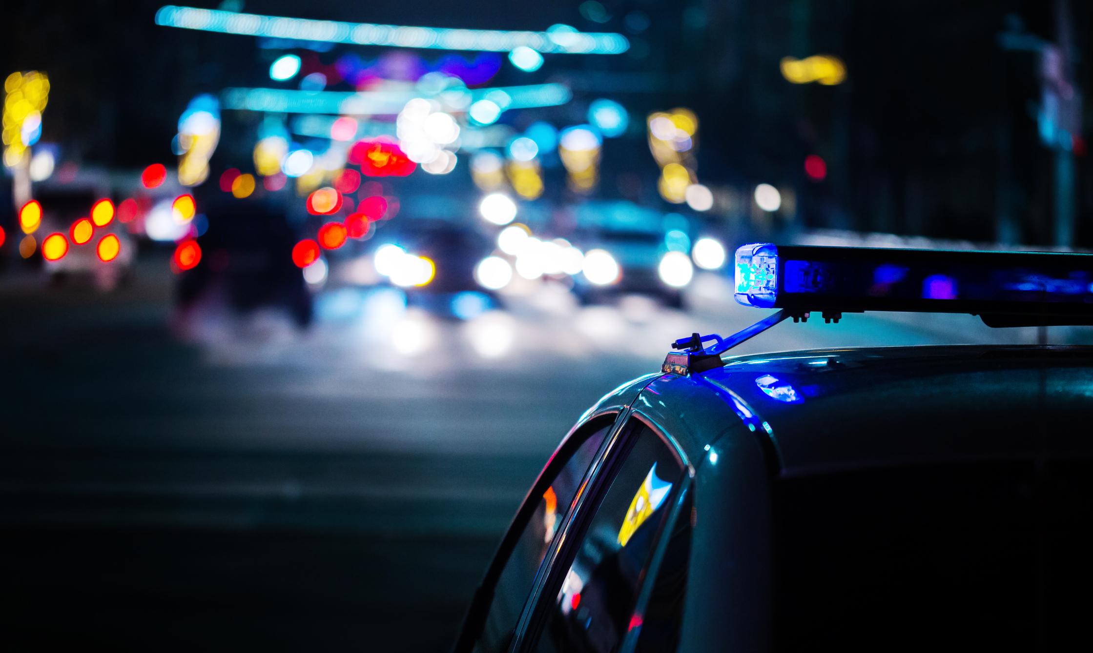 Image of emergency services vehicles at a night scene of an incident
