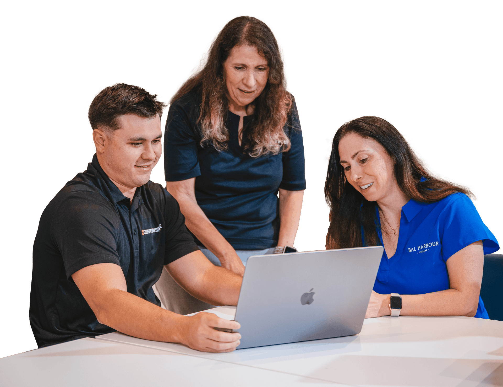 A CentralSquare employee shirt working with two customers looking at a computer and smiling.